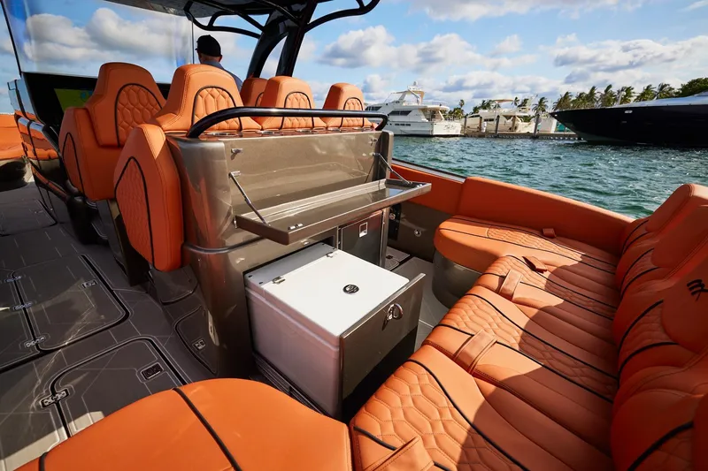  Yacht Photos Pics Luxurious interior of Midnight Express 37' Open boat with orange seating and scenic marina view.