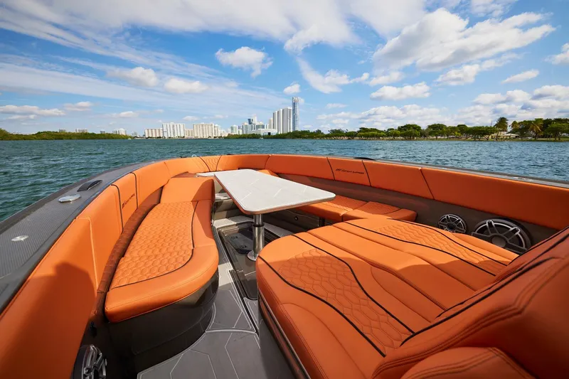  Yacht Photos Pics Luxurious Midnight Express 37' Open boat with orange seating, city skyline in background.