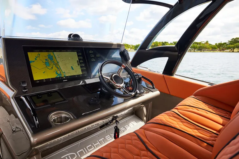  Yacht Photos Pics Cockpit of Midnight Express 37' Open boat with navigation display and luxurious seating.