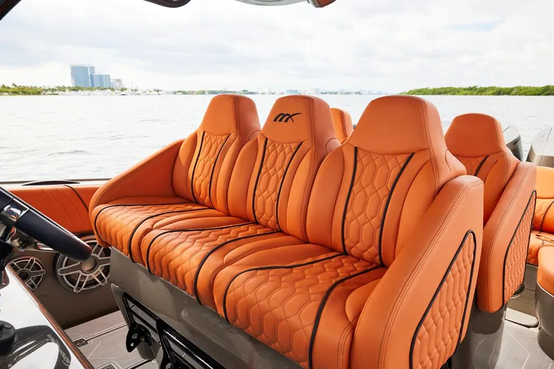  Yacht Photos Pics Luxurious orange seating on a Midnight Express 37' Open boat, with scenic water view.