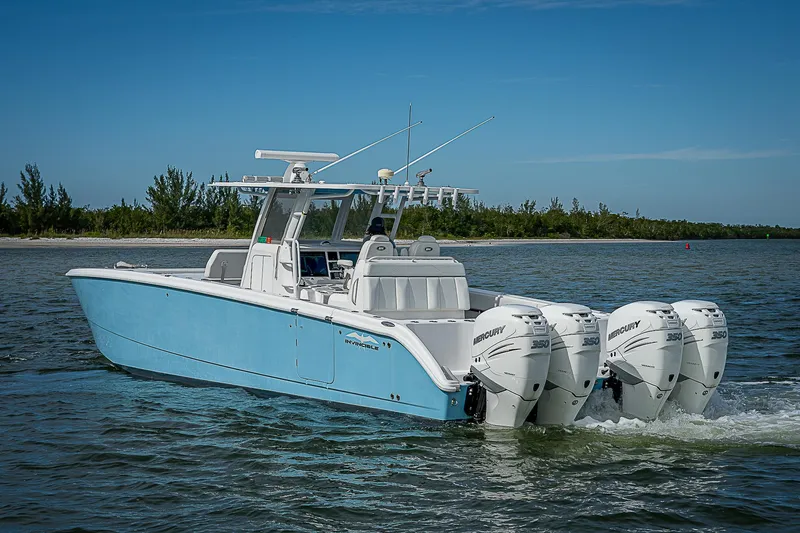  Yacht Photos Pics 2020 Invincible 37 Catamaran with four Mercury engines cruising on a calm waterway.