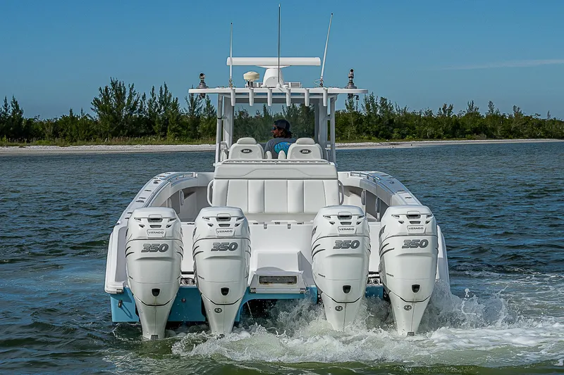  Yacht Photos Pics 2020 Invincible 37 Catamaran with four powerful outboard engines cruising on water.