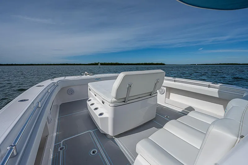  Yacht Photos Pics Invincible 37 Catamaran 2020, spacious deck with seating, on calm waters under clear sky.