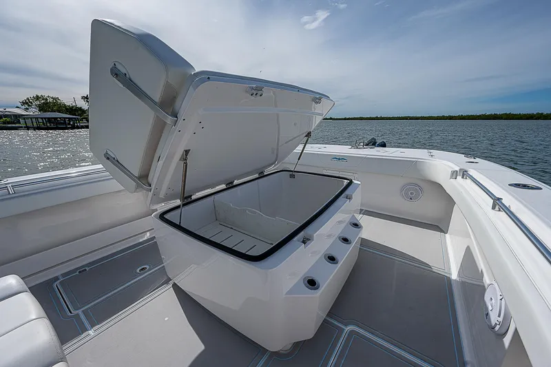  Yacht Photos Pics 2020 Invincible 37 Catamaran with open storage compartment on deck, near water.