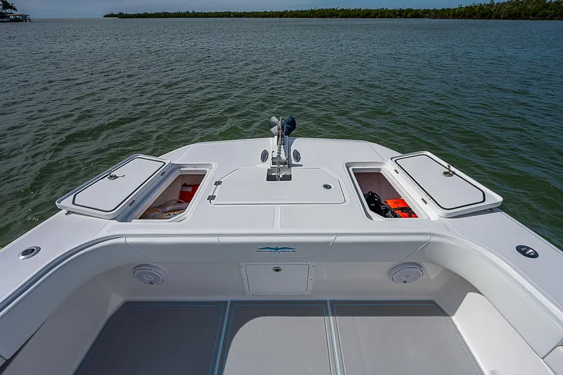  Yacht Photos Pics 2020 Invincible 37 Catamaran deck with storage compartments, anchored on calm waters.