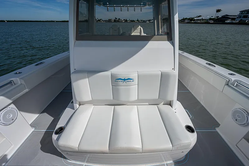  Yacht Photos Pics 2020 Invincible 37 Catamaran with white seating, on calm water.