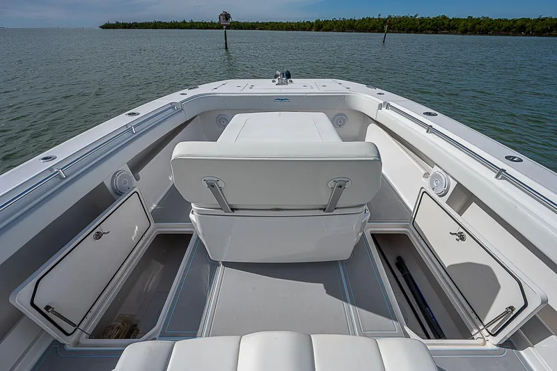  Yacht Photos Pics 2020 Invincible 37 Catamaran interior with open storage compartments on calm water.