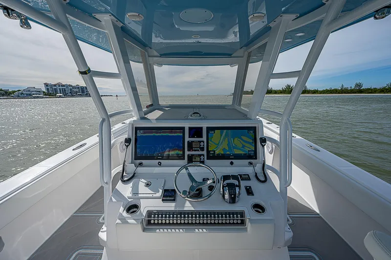  Yacht Photos Pics 2020 Invincible 37 Catamaran helm with dual screens on open water.