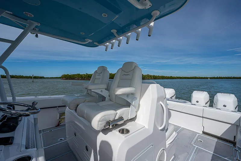  Yacht Photos Pics Invincible 37 Catamaran 2020 with dual helm seats, ocean view, and multiple outboard engines.