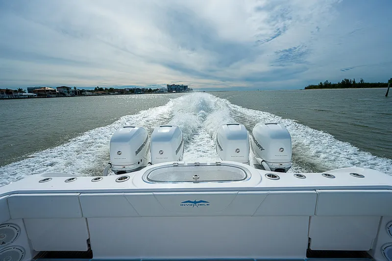  Yacht Photos Pics 2020 Invincible 37 Catamaran with four engines cruising on open water.