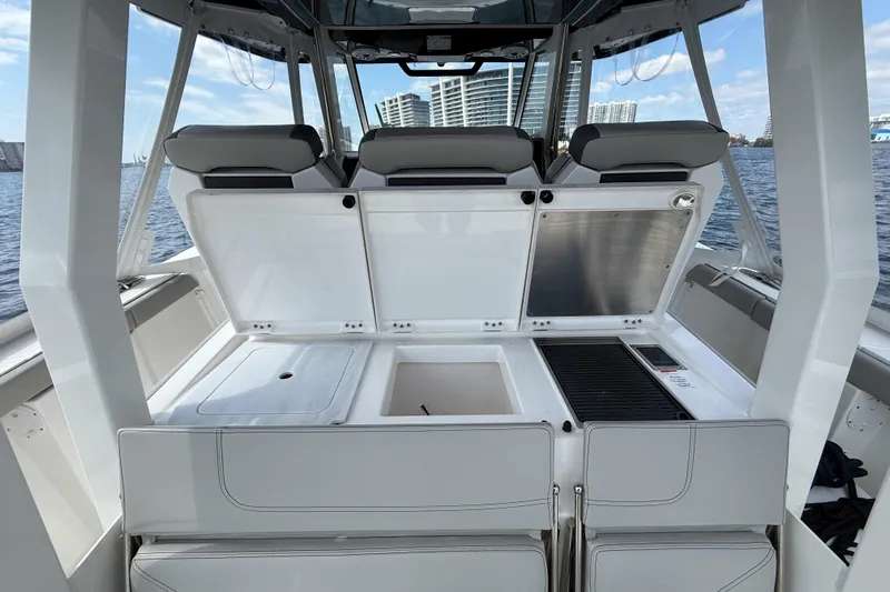 Alroma Yacht Photos Pics 2022 Pursuit S 358 Sport boat interior with open storage compartments and seating.