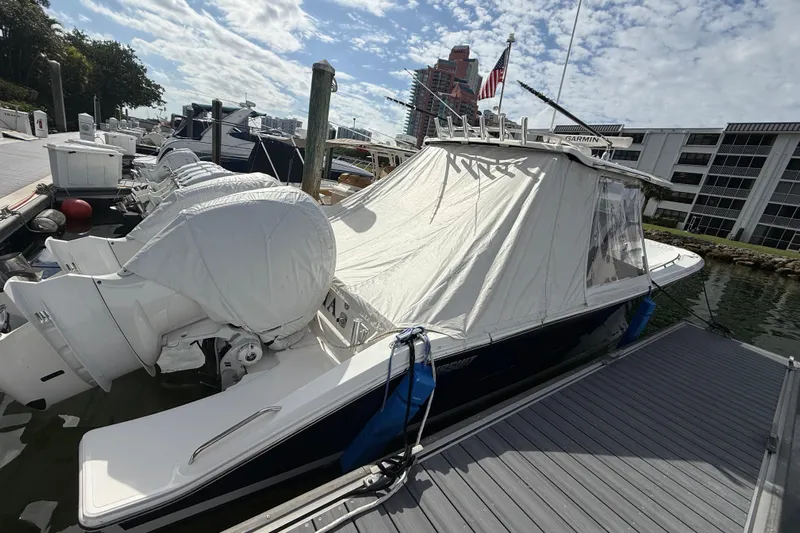 Alroma Yacht Photos Pics 2022 Pursuit S 358 Sport boat docked with covered engines and canopy.