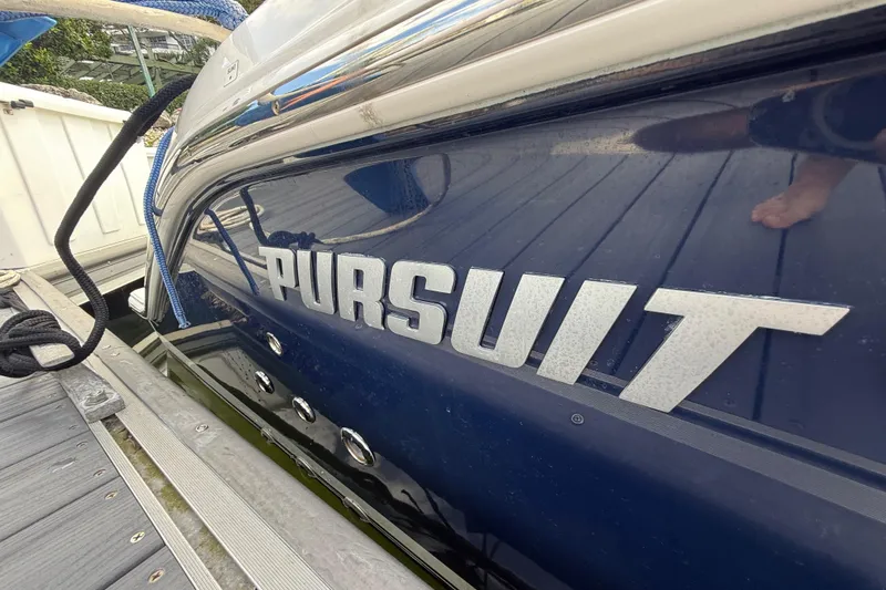Alroma Yacht Photos Pics 2022 Pursuit S 358 Sport boat docked, showcasing sleek design and branding.