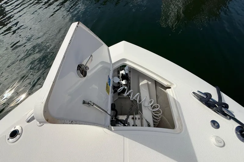 Alroma Yacht Photos Pics 2022 Pursuit S 358 Sport boat anchor compartment open on calm water.