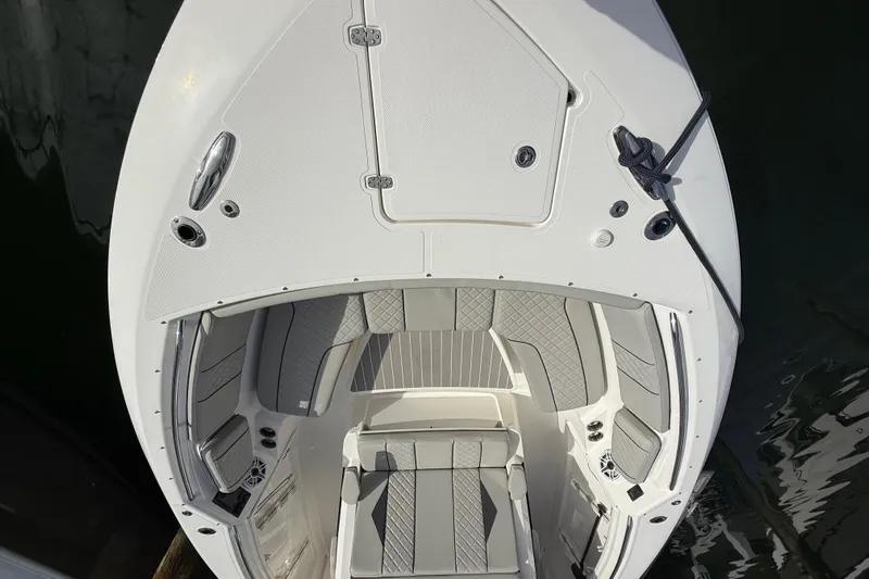 Alroma Yacht Photos Pics 2022 Pursuit S 358 Sport boat, top view of bow seating area with gray upholstery.