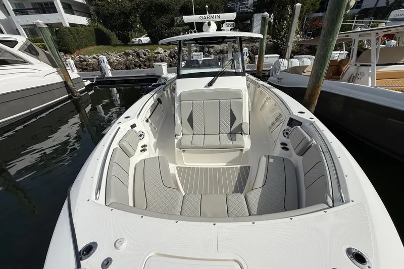 Alroma Yacht Photos Pics 2022 Pursuit S 358 Sport boat with spacious seating and modern design at a marina.