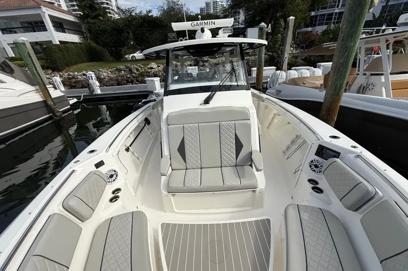 Alroma Yacht Photos Pics 2022 Pursuit S 358 Sport boat with luxurious seating and modern design at a marina.