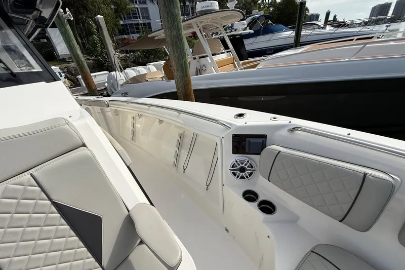 Alroma Yacht Photos Pics 2022 Pursuit S 358 Sport boat interior with cushioned seating and modern controls.