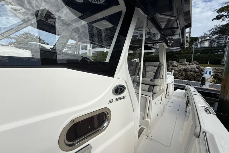 Alroma Yacht Photos Pics 2022 Pursuit S 358 Sport boat, sleek design, docked with luxurious seating.