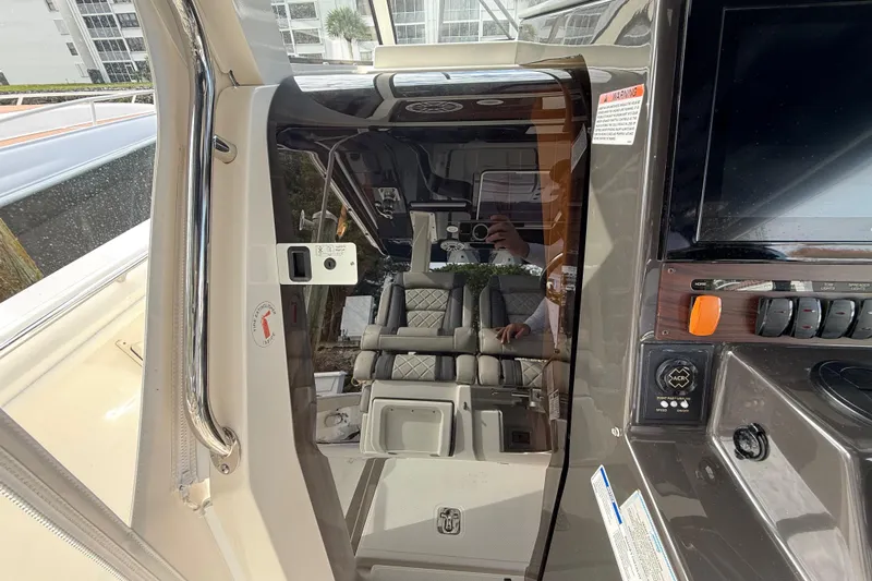 Alroma Yacht Photos Pics 2022 Pursuit S 358 Sport boat interior with control panel and seating area.