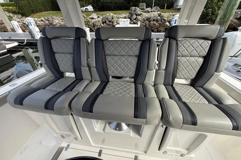 Alroma Yacht Photos Pics 2022 Pursuit S 358 Sport boat seats with quilted gray and black upholstery.
