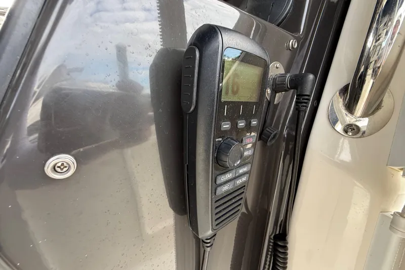 Alroma Yacht Photos Pics Marine radio on 2022 Pursuit S 358 Sport boat, mounted on a sleek panel.