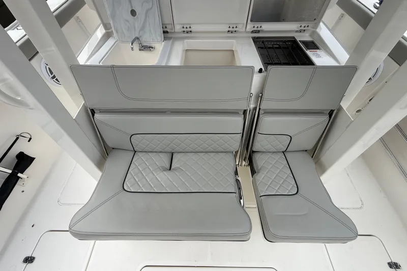 Alroma Yacht Photos Pics 2022 Pursuit S 358 Sport boat interior with foldable seats and kitchenette.