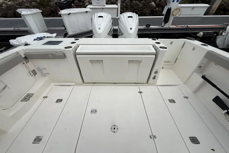 Alroma Yacht Photos Pics 2022 Pursuit S 358 Sport boat deck with storage compartments and outboard motors.