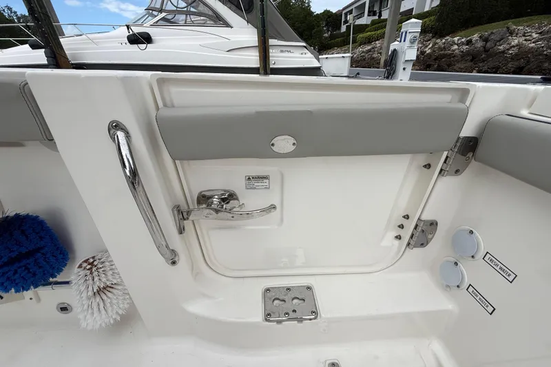 Alroma Yacht Photos Pics 2022 Pursuit S 358 Sport boat interior with door, handle, and water access points.