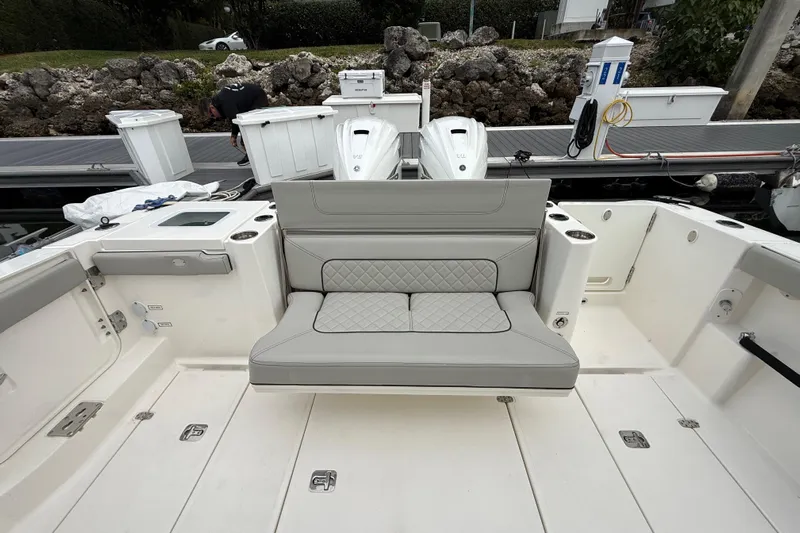 Alroma Yacht Photos Pics 2022 Pursuit S 358 Sport boat interior with cushioned seating and storage compartments.