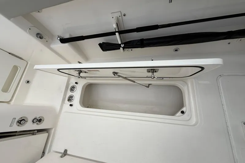 Alroma Yacht Photos Pics 2022 Pursuit S 358 Sport boat storage compartment with open hatch and visible interior.