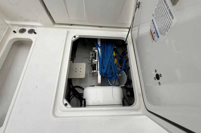 Alroma Yacht Photos Pics 2022 Pursuit S 358 Sport boat storage compartment with blue ropes and equipment.