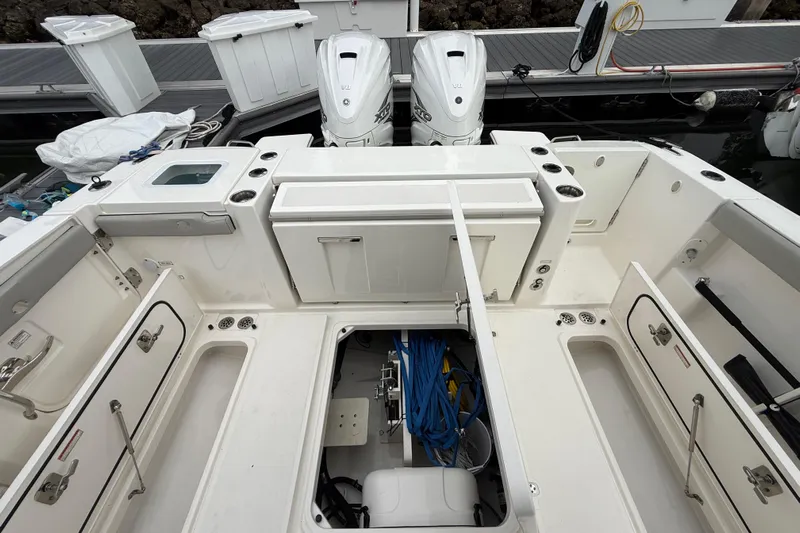 Alroma Yacht Photos Pics 2022 Pursuit S 358 Sport boat interior with storage compartments and twin outboard engines.