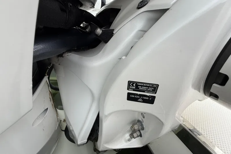 Alroma Yacht Photos Pics Close-up of 2022 Pursuit S 358 Sport boat engine details and label.