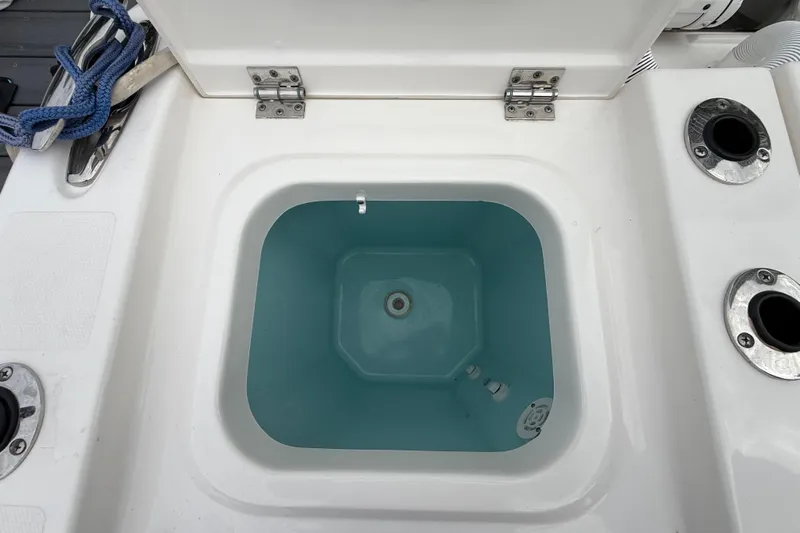 Alroma Yacht Photos Pics Livewell compartment on a 2022 Pursuit S 358 Sport boat, featuring rod holders.