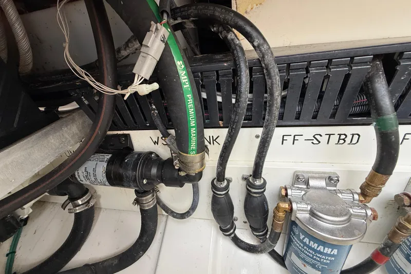 Alroma Yacht Photos Pics Engine compartment of 2022 Pursuit S 358 Sport with marine hoses and Yamaha fuel filter.