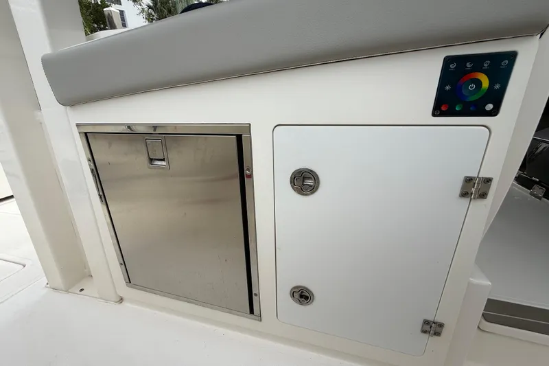 Alroma Yacht Photos Pics 2022 Pursuit S 358 Sport boat interior with storage compartments and control panel.
