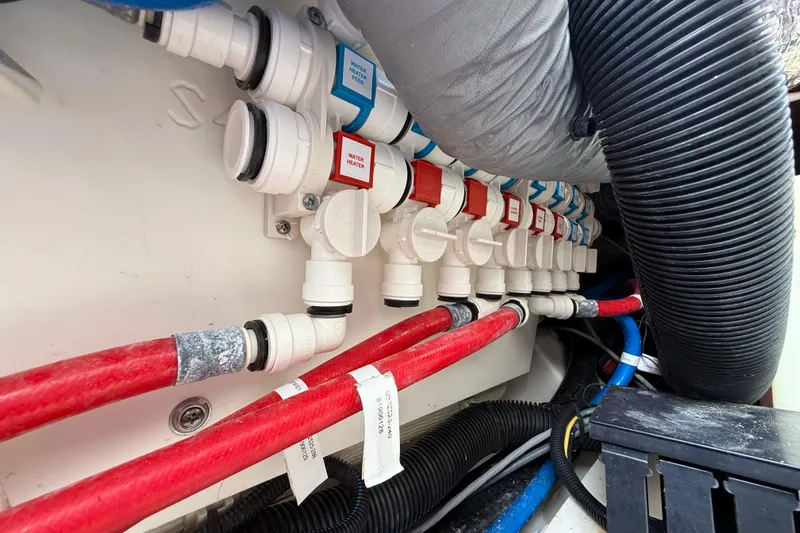 Alroma Yacht Photos Pics Boat plumbing system with labeled valves and hoses in a 2022 Pursuit S 358 Sport.