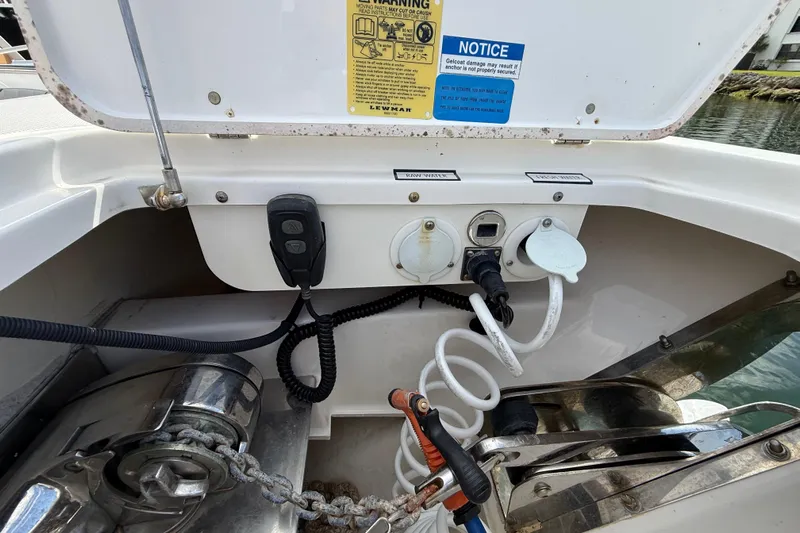 Alroma Yacht Photos Pics 2022 Pursuit S 358 Sport boat anchor compartment with controls and hoses.
