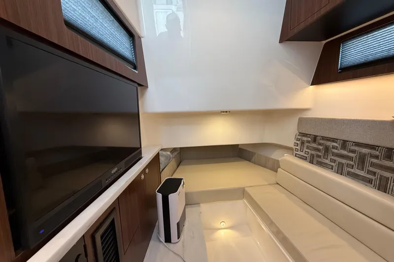 Alroma Yacht Photos Pics Luxurious interior of 2022 Pursuit S 358 Sport boat with modern seating and entertainment system.
