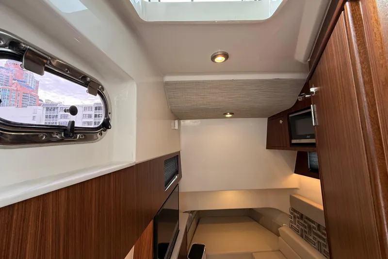 Alroma Yacht Photos Pics Interior of 2022 Pursuit S 358 Sport boat, featuring wood paneling and modern amenities.