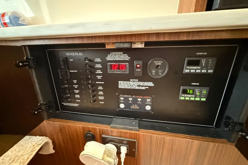 Alroma Yacht Photos Pics Control panel of a 2022 Pursuit S 358 Sport boat, featuring various switches and displays.