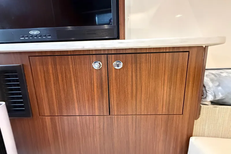 Alroma Yacht Photos Pics Wooden cabinet with chrome handles in 2022 Pursuit S 358 Sport boat interior.