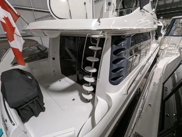 Her Endeavour II Yacht Photos Pics 1999 Carver 530 Voyager Pilothouse yacht docked indoors with Canadian flag.