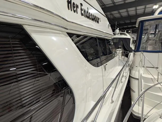 Her Endeavour II Yacht Photos Pics 1999 Carver 530 Voyager Pilothouse yacht docked indoors, side view.