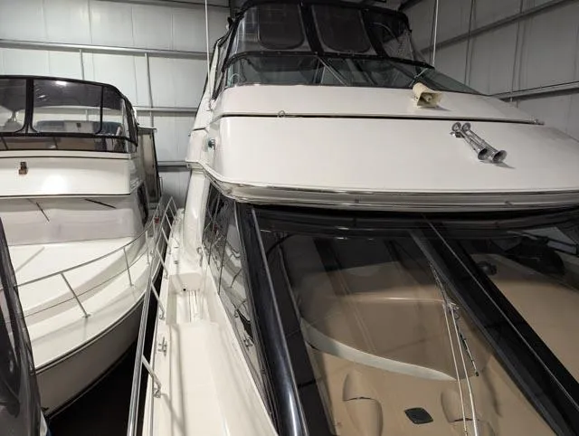 Her Endeavour II Yacht Photos Pics 1999 Carver 530 Voyager Pilothouse yacht in storage, showcasing sleek design and spacious deck.