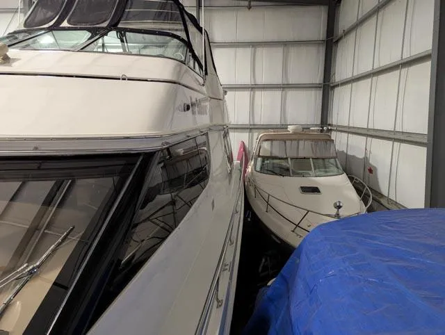 Her Endeavour II Yacht Photos Pics 1999 Carver 530 Voyager Pilothouse yacht stored indoors alongside another boat.