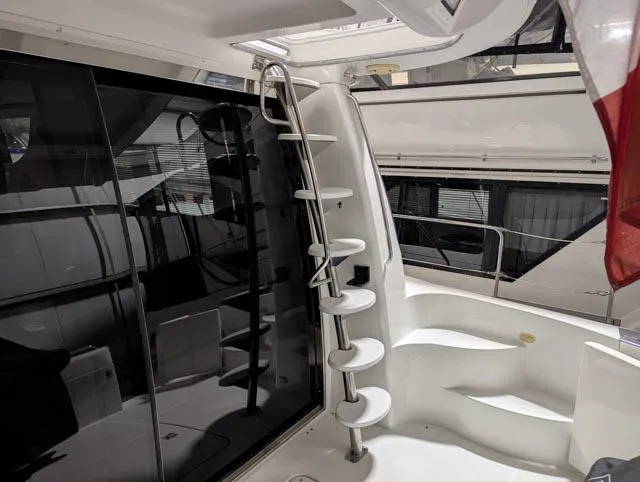 Her Endeavour II Yacht Photos Pics 1999 Carver 530 Voyager Pilothouse yacht interior with spiral staircase and glass doors.