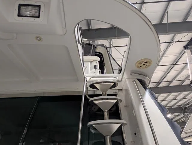 Her Endeavour II Yacht Photos Pics 1999 Carver 530 Voyager Pilothouse yacht interior with spiral staircase, under a metal roof.