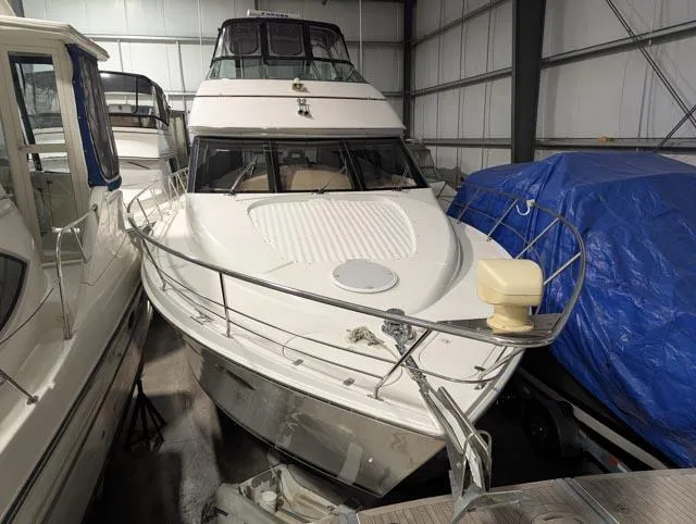 Her Endeavour II Yacht Photos Pics 1999 Carver 530 Voyager Pilothouse yacht in storage, front view, indoor setting.